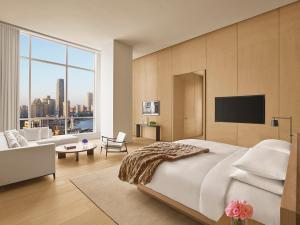 a bedroom with a large bed and a large window at The Shanghai EDITION in Shanghai