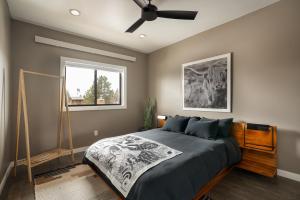 a bedroom with a bed and a ceiling fan at Wallace BNB in Pinedale