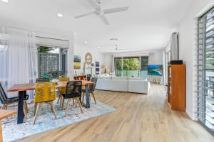 a dining room and living room with a table and chairs at A Tropical Family Oasis in Sunshine Beach in Sunshine Beach