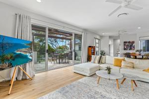 a living room with a couch and a table at A Tropical Family Oasis in Sunshine Beach in Sunshine Beach