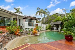 a backyard with a pool and a house at A Tropical Family Oasis in Sunshine Beach in Sunshine Beach