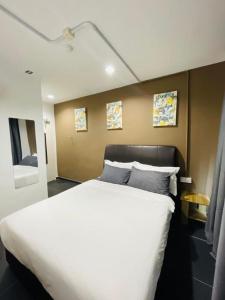 ein Schlafzimmer mit einem großen weißen Bett mit zwei Kissen in der Unterkunft Halo Rooms Hotel in Wakaf Baharu