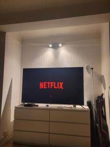 a television on a dresser with a netflix sign on it at En plein cœur de Paris Saint-Lazare Hausman / Paris center Hausman Opera in Paris