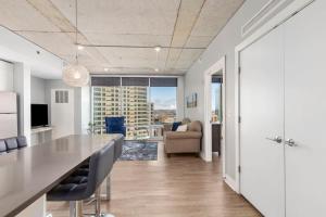 a kitchen and living room with a table and chairs at Luxury 2BR Penthouse in Downtown GR in Grand Rapids