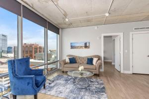 a living room with a couch and a table at Luxury 2BR Penthouse in Downtown GR in Grand Rapids