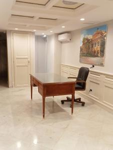 a desk and a chair in a room at Federico 70 Acquamarina in Palermo