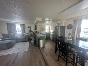 a kitchen and living room with a table and a couch at Newly Remodeled Relaxing Stay near Downtown in Fairbanks