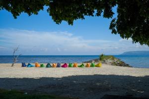 a group of colorful umbrellas on the beach at Samawa Seaside Resort in Sumbawa Besar