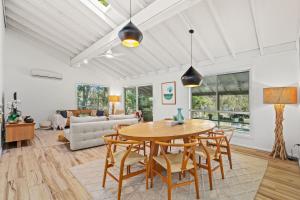 a living room with a table and chairs at Scenic 4-Bed Lake House 5-min Walk to Avoca Beach in Avoca Beach