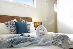a bed with a blanket and towels on it at Sorrento Del Mar by Ready Set Stay in Sorrento