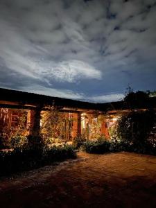 un edificio de ladrillo con luces encendidas por la noche en Huayápam Yù'ú Lodge en San Andrés Huayapan