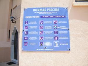 a blue sign on the side of a building at Apartamento Playa de Gandía, 3 dormitorios, 7 personas - ES-314-11 in Gandía