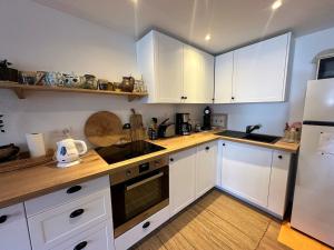 a kitchen with white cabinets and white appliances at Appartement Vars, 4 pièces, 6 personnes - FR-1-773-25 in Vars