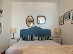 a bedroom with a large bed with two mirrors at B&B La Bergerie in Taormina