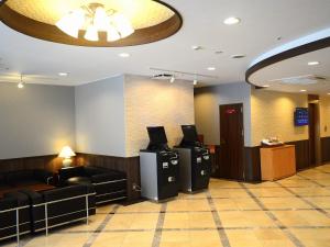 a lobby with a waiting room with a light on the ceiling at Sunwest Hotel Sasebo in Sasebo