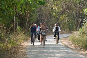 a group of people riding bikes down a road at Đức Phát Homestay in Tân Phú