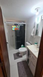 a small bathroom with a toilet and a sink at Refugio Bela Ilha via Barco in Florianópolis