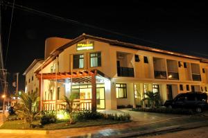 a building with a car parked in front of it at San Manuel Praia Hotel in Aracaju