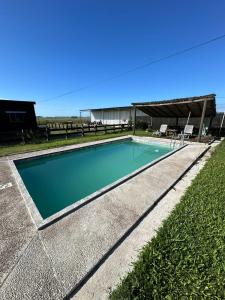 a swimming pool in the middle of a yard at 0 es 3 Uno in Treinta y Tres