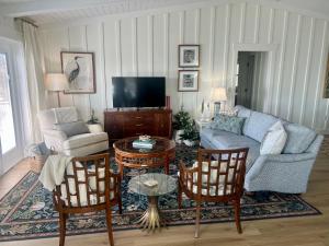 a living room with a couch and a tv at Lakefront Duplex With Pontoon Boat Downtown in Mount Dora