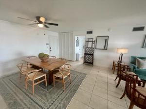 a living room with a table and chairs and a couch at Lakefront Duplex With Pontoon Boat Downtown in Mount Dora