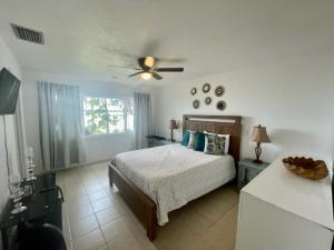a bedroom with a bed and a ceiling fan at Lakefront Duplex With Pontoon Boat Downtown in Mount Dora