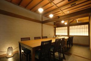 a large dining room with a table and chairs at Keishokan Sazanamitei in Fukuyama