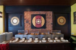 a buffet line with plates and appetizers at Pinnacle Samui Resort in Mae Nam