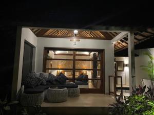 a living room with a couch in front of a window at Bali Santi Bungalows in Candidasa