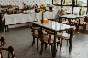 a table with a vase of sunflowers on it in a restaurant at Arun Dara Villa in Chiang Mai