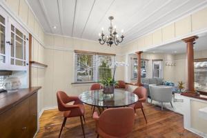 a dining room with a glass table and chairs at Cute Hillcrest cottage in San Diego