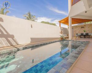a swimming pool in front of a house at MSLodge in Kani Keli