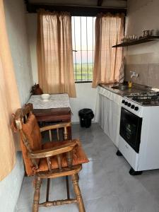 a kitchen with a table and a stove at 0 es 3 Dos in Treinta y Tres