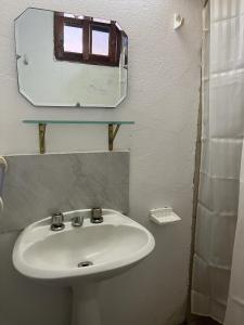 a bathroom with a sink and a mirror at 0 es 3 Dos in Treinta y Tres