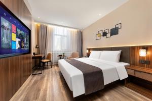 Voodi või voodid majutusasutuse HomeInn Selection Harbin Central Street Sophia Church toas