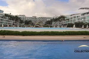 a swimming pool in front of a resort at Nuevo Estudio en Aria Ocean 609 in Nuevo Vallarta +11 photos