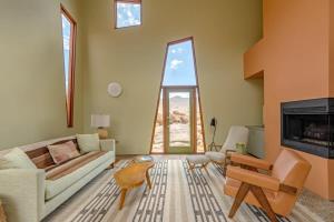a living room with a couch and a fireplace at Josh Schweitzer's Monument House Joshua Tree in Joshua Tree