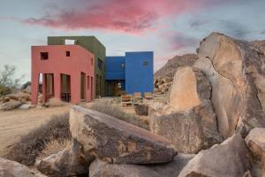 a building with some rocks in front of it at Josh Schweitzer's Monument House Joshua Tree in Joshua Tree