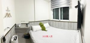 Ένα ή περισσότερα κρεβάτια σε δωμάτιο στο Xiaomi Courtyard B&B