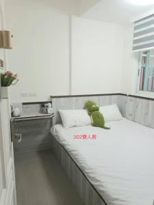 Ένα ή περισσότερα κρεβάτια σε δωμάτιο στο Xiaomi Courtyard B&B