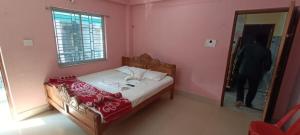 a bed in a pink bedroom with a mirror at Hotel Chemistrica Digha - Couple Friendly - Best Location in Digha