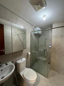 een badkamer met een douche, een toilet en een wastafel bij Pollux High Rise Apartments at Batam Center with Netflix by MESA in Batam Center