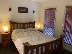 a bedroom with a bed and two lamps on tables at Cowes Luxury Getaway in Cowes
