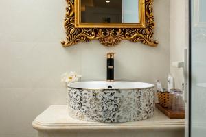 a bathroom with a sink and a mirror at Hanoi Oldtown Nomad Hostel & Pub in Hanoi +36 photos