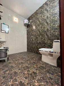 a bathroom with a toilet and a sink at HOTEL THE GRAND REGENCY -- Luxury Rooms Stay -- Family, Couples, Corporate Special in Ludhiana