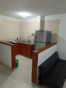 a kitchen with a stove and a refrigerator in it at Apartamento familiar San Gil in San Gil