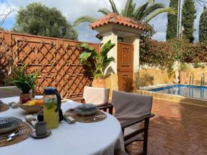 a table with a bowl of fruit on a patio at Pool Garden House near the Sea in Vari