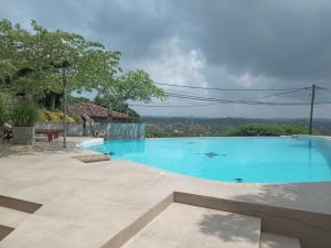 a large blue swimming pool in a yard at The Lady Hill Hotel in Galle +51 photos