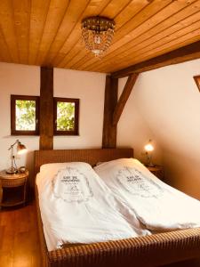 a bed in a room with a wooden ceiling at Ferienwohnungen auf einem ehemaligen Bauernhof in Neuhausen