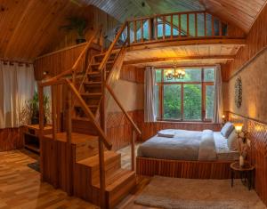 a bedroom with a bed and a spiral staircase at Whoopers Boutique Resort Jibhi in Jibhi